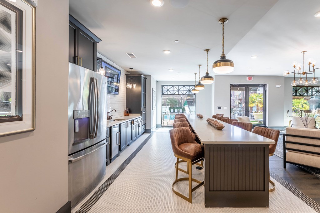 a kitchen with stainless steel appliances and a long table