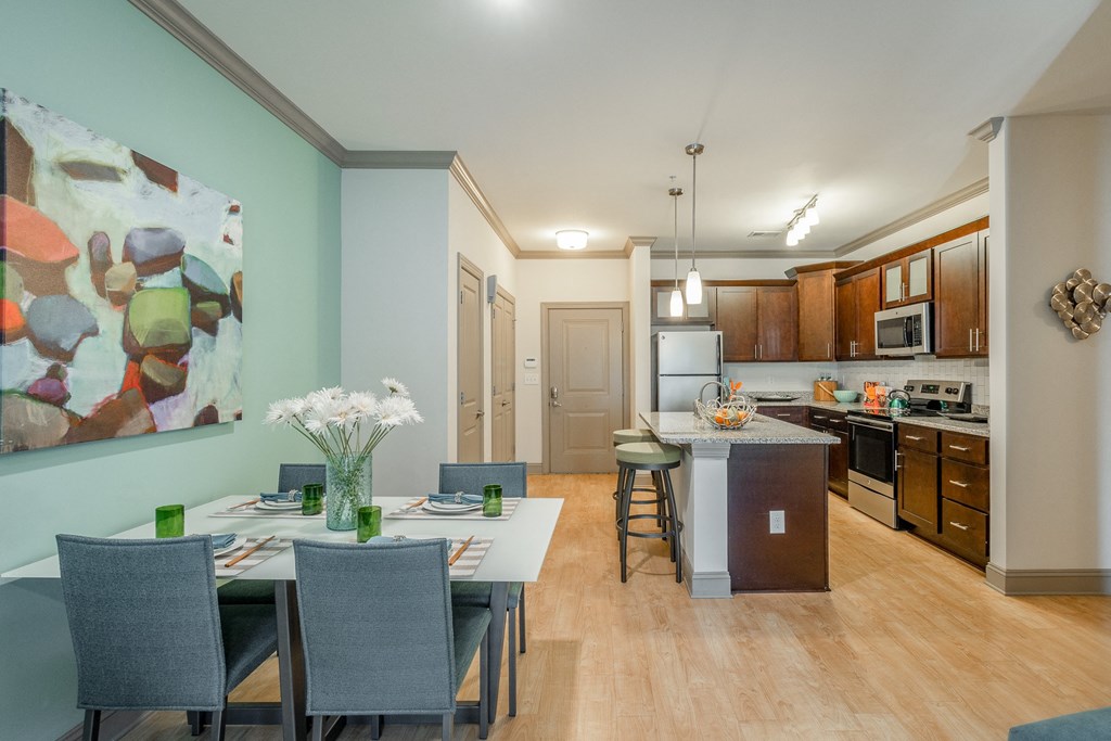 an open kitchen and dining room with a table and chairs