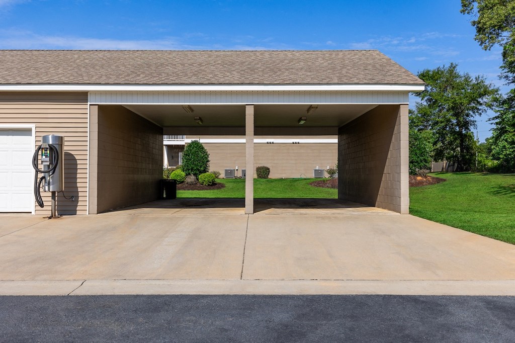 a covered parking lot in front of a house