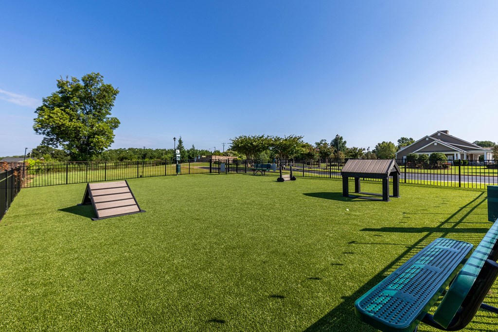 Amenities a park with a playground and a picnic table