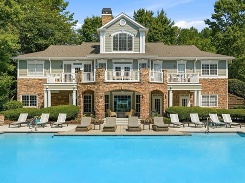 A large house with a pool in front.