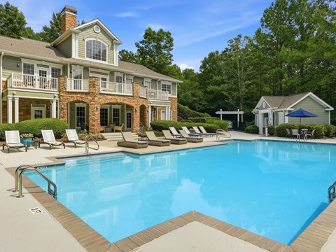 A large house with a pool in front.