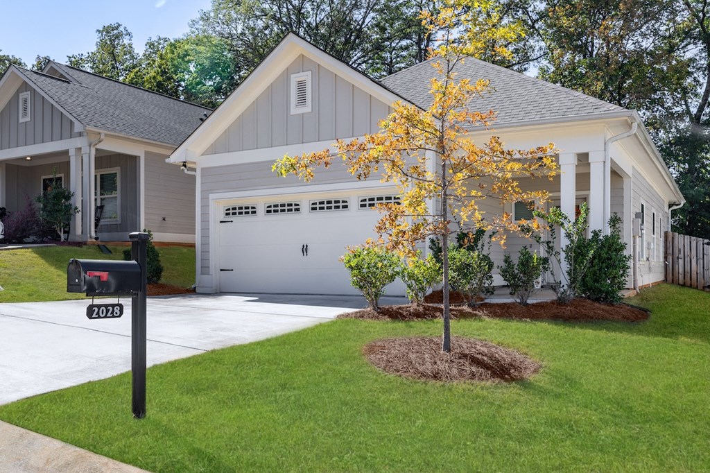 A house with a tree in front of it.