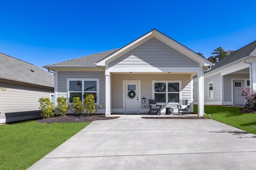 A house with a front yard and a driveway.