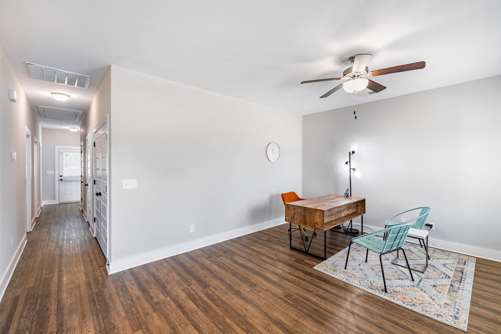 A room with a wooden table and chairs.