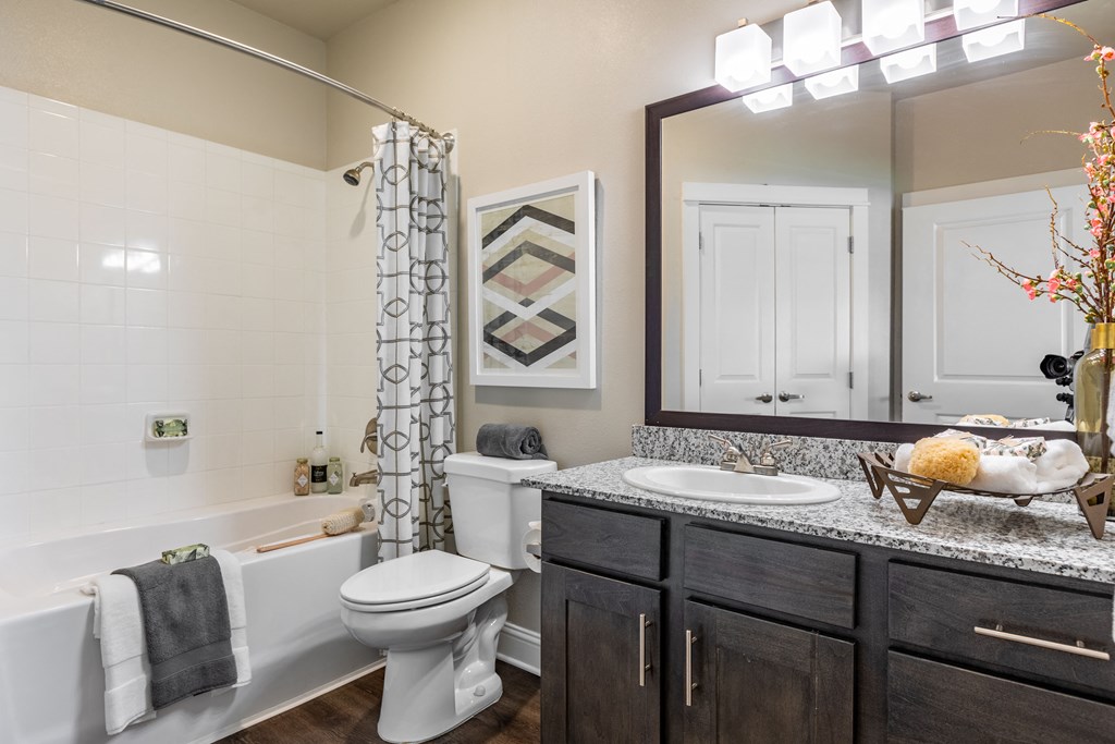 an open bathroom with a toilet sink and tub and a shower