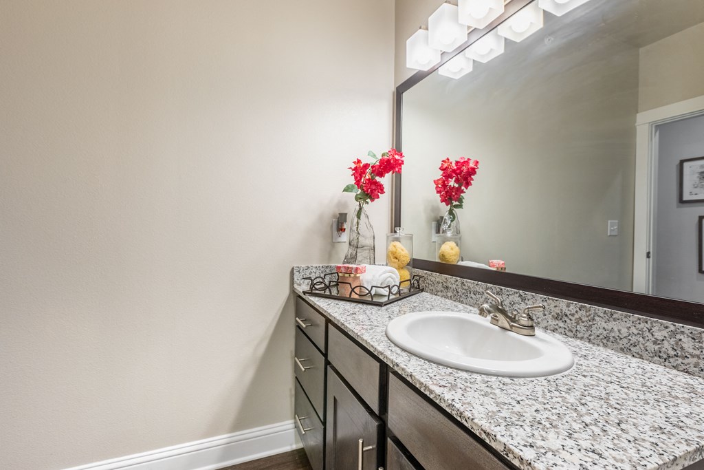 an empty bathroom with a sink and a mirror
