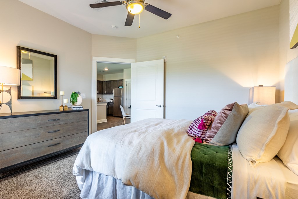 a bedroom with a large bed and a ceiling fan
