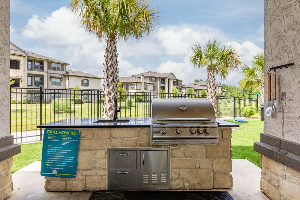 the preserve at ballantyne commons clubhouse with a grill and palm trees