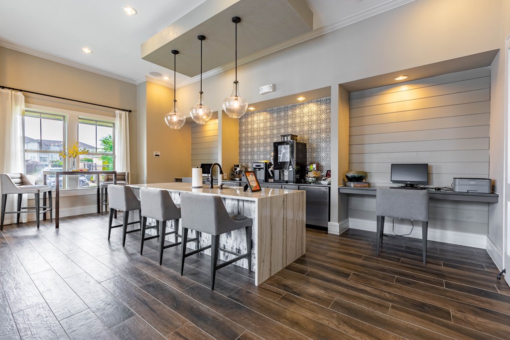 a kitchen and dining area with a bar and chairs and a television
