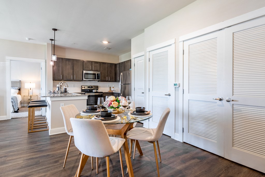 a kitchen and dining room with a table and chairs