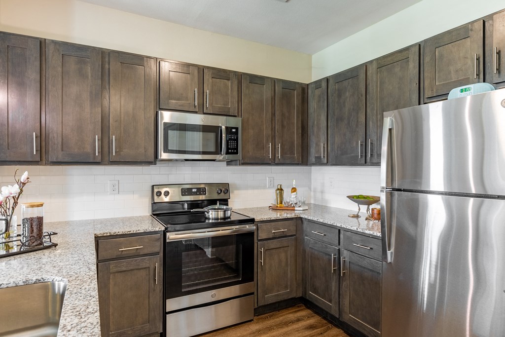 a kitchen with stainless steel appliances and wooden cabinets