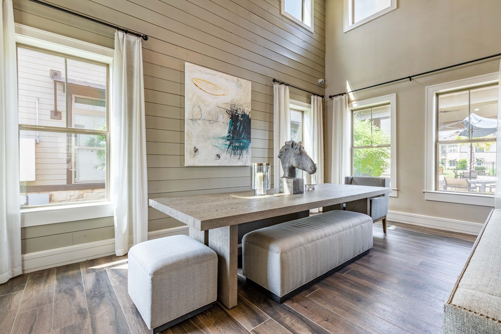 a dining room with a long table and a horse statue