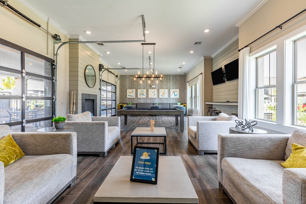 a living room with couches and a table in front of a fireplace