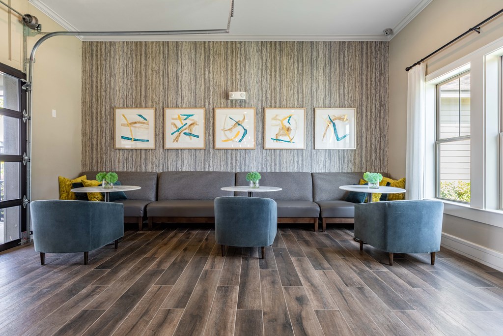 a lobby with couches and chairs and artwork on the wall