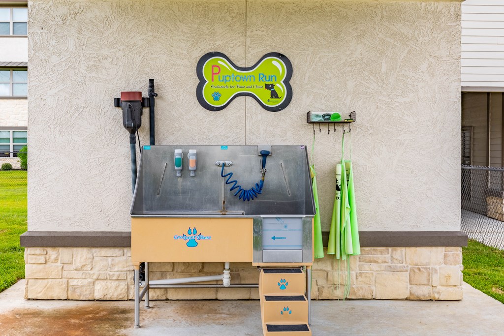 a barbecue grill outside of a building with a sign on the wall