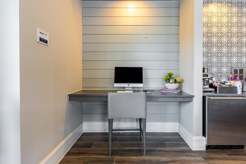 a home office with a computer desk and a chair