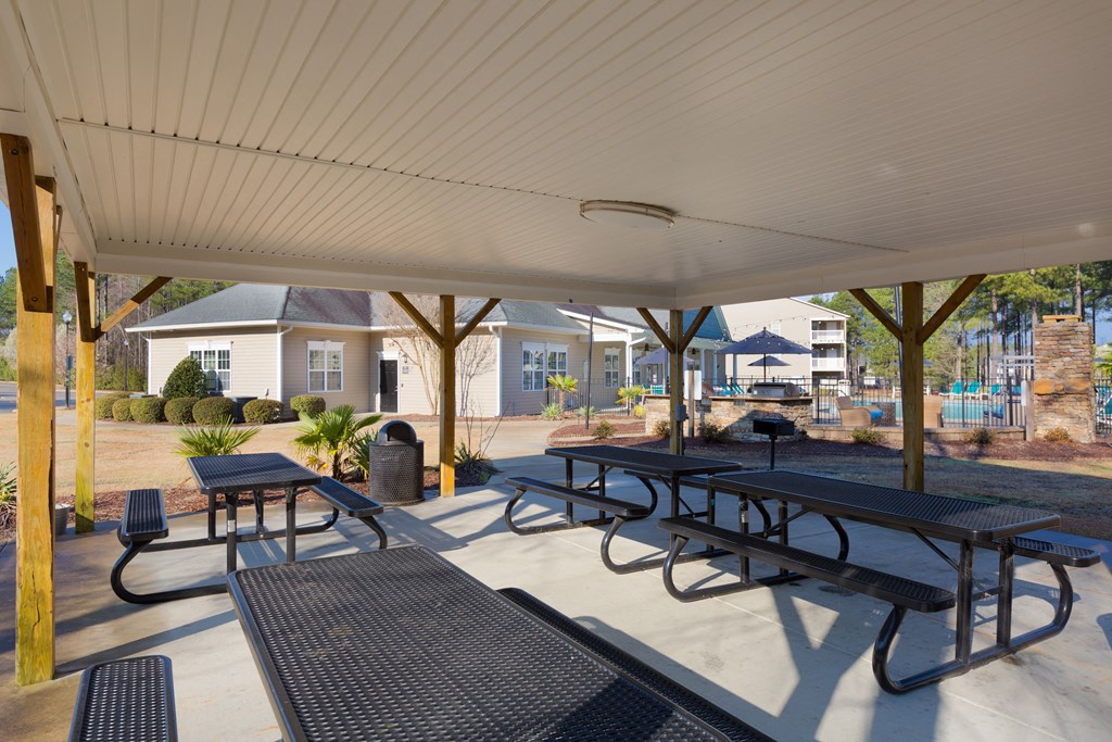 A covered picnic area with tables and benches.