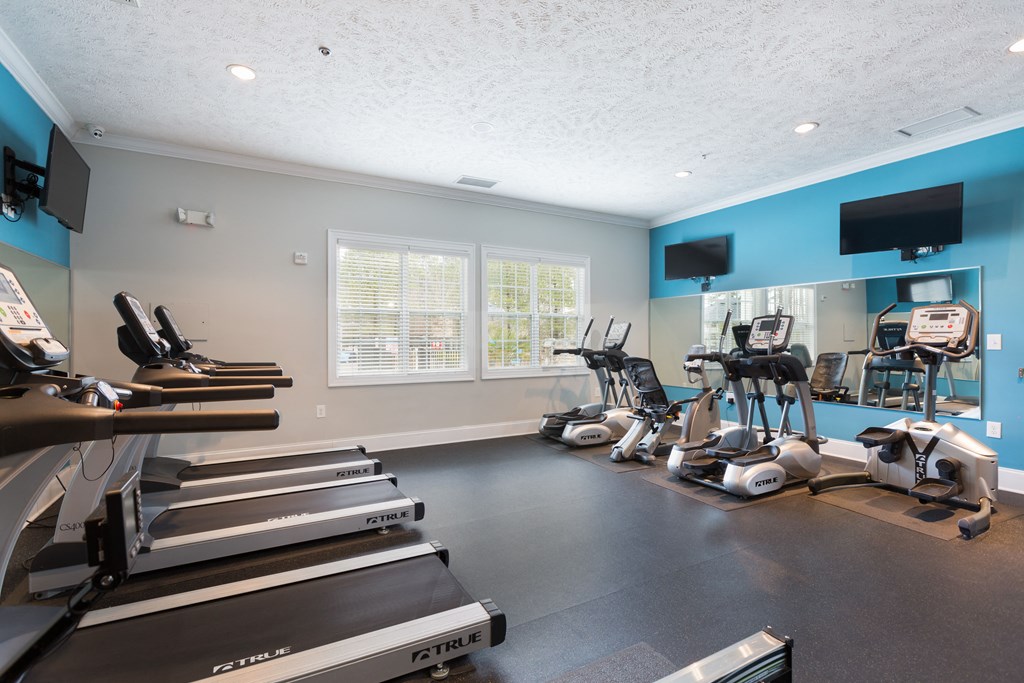 A gym with treadmills and exercise bikes.