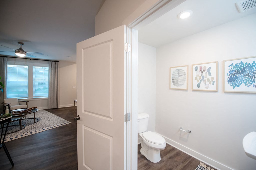 a bathroom with a white toilet next to a white sink