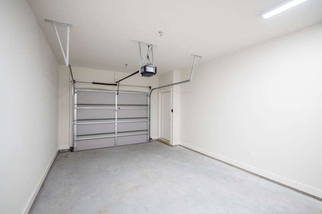 a bedroom with white walls and a garage with a white door