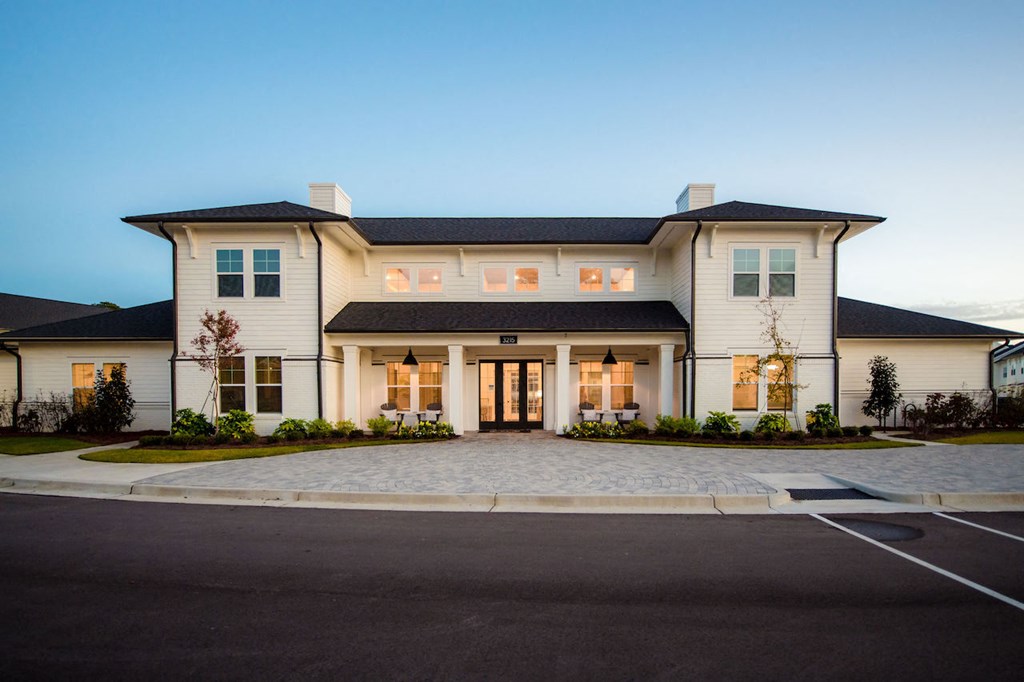 a large white house with a large driveway