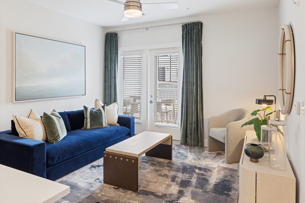 A blue couch with a white table in front of it at Parker Apartments in Raleigh, NC.