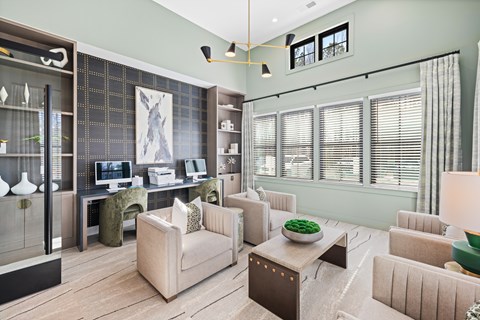 A modern clubhouse with a green accent wall and a large window with blinds Parker Apartments in Raleigh, NC.