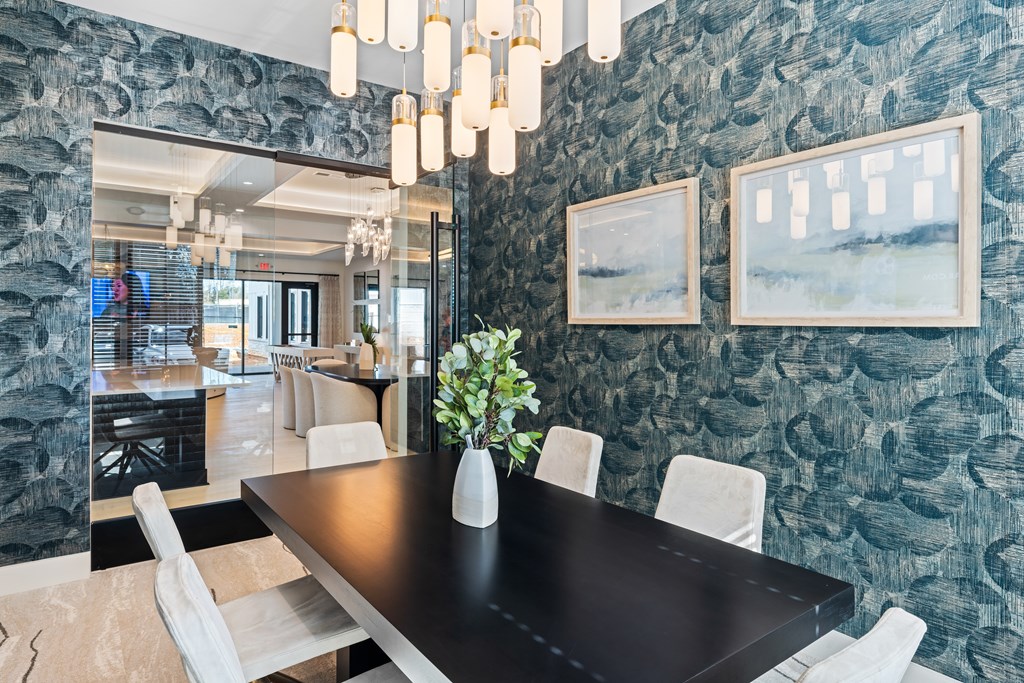 A seating area with a black table and chairs at Parker Apartments in Raleigh, NC.