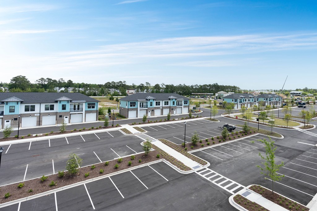 an empty parking lot in a neighborhood with houses