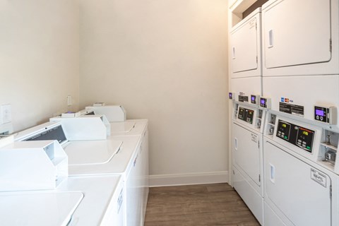 a kitchen with white appliances and a counter top and a refrigerator