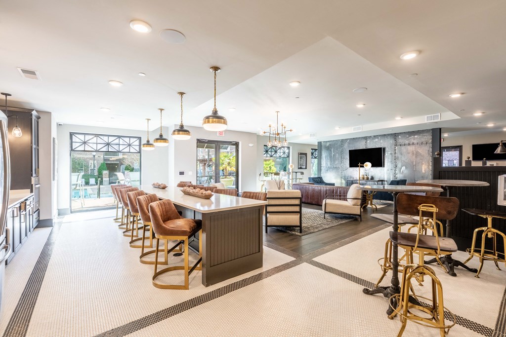 the lobby of a restaurant with a bar and tables and chairs