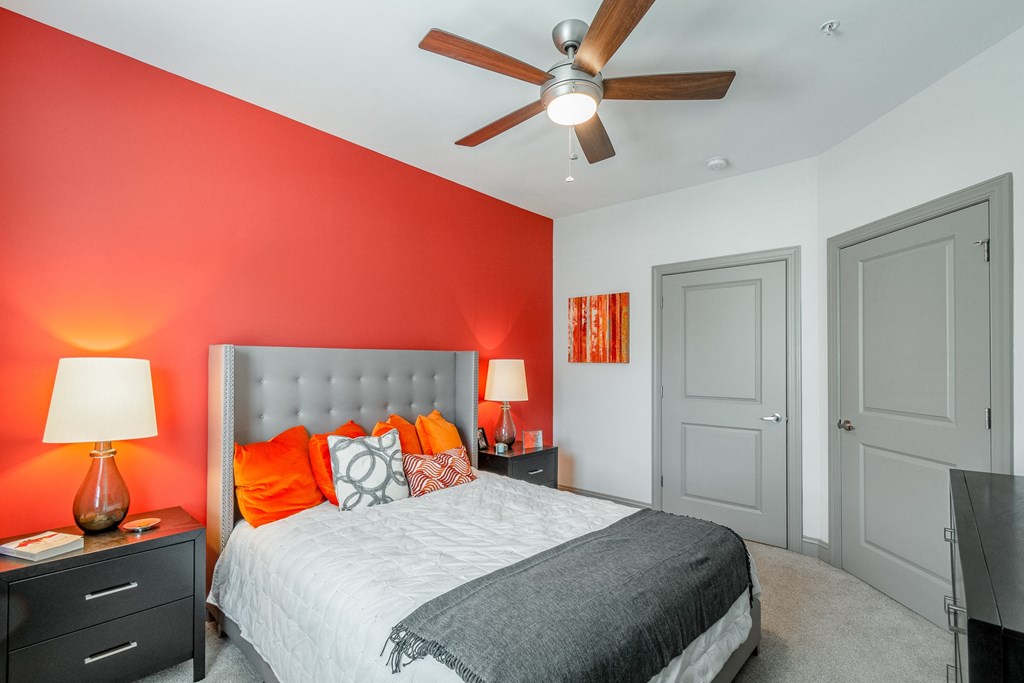 a bedroom with a bed and a ceiling fan