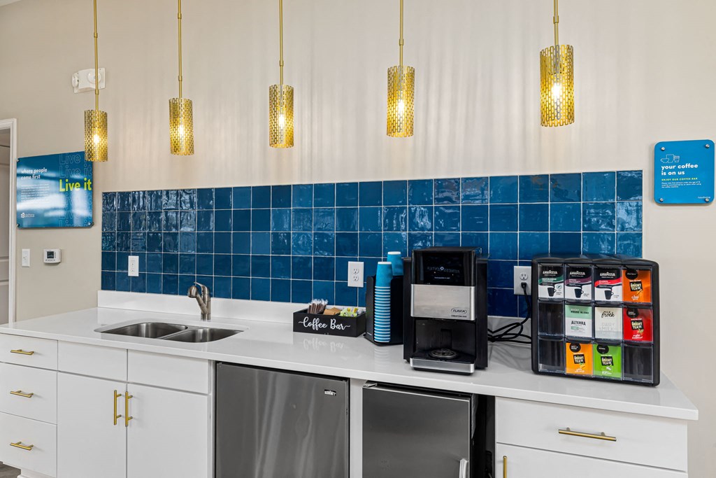 a kitchen with blue tiles and white counter tops and a sink