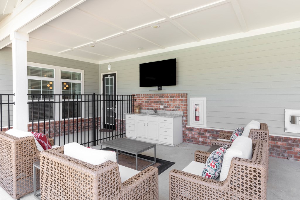 a living room with furniture and a television on the wall