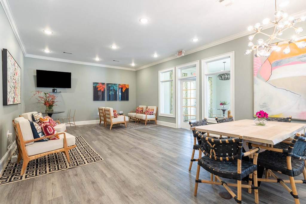 a living room with a dining room table and chairs