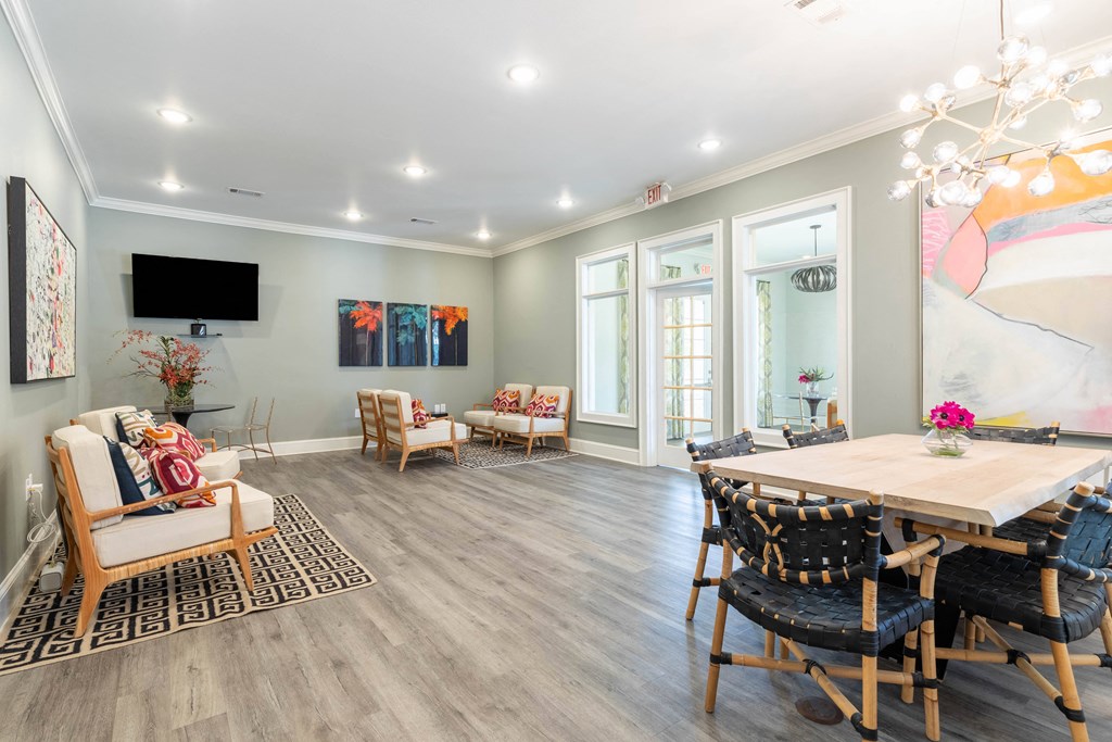 a living room with a dining room table and chairs