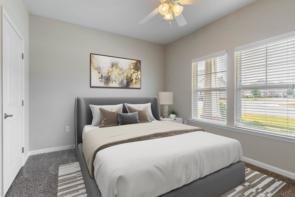 a bedroom with a large bed and a ceiling fan