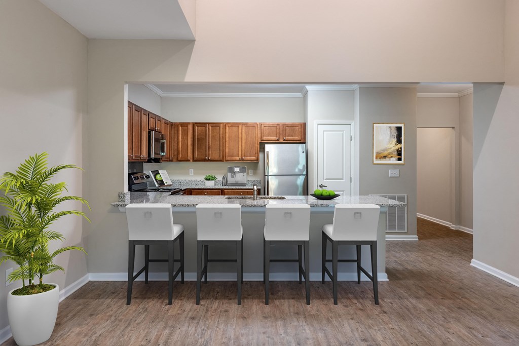 a kitchen with a large island with white chairs