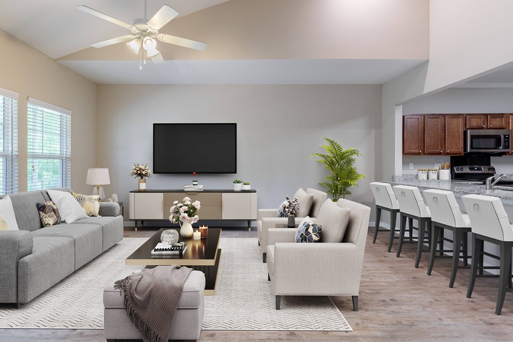 a living room with couches and chairs and a kitchen with a tv