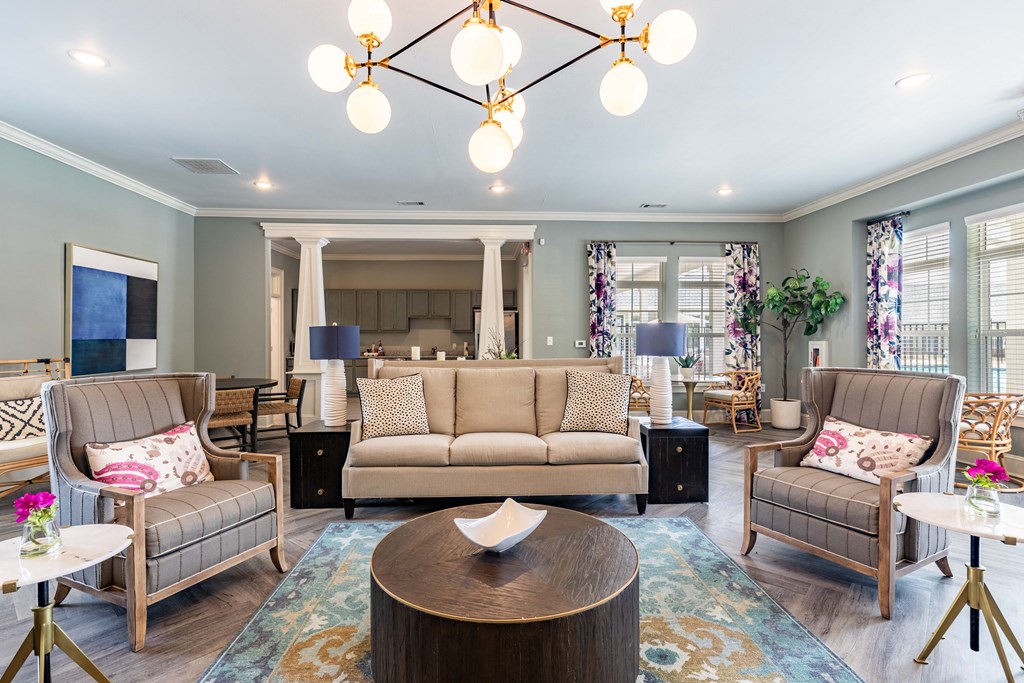 a living room with couches and chairs