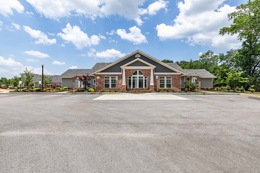 an empty parking lot in front of a house