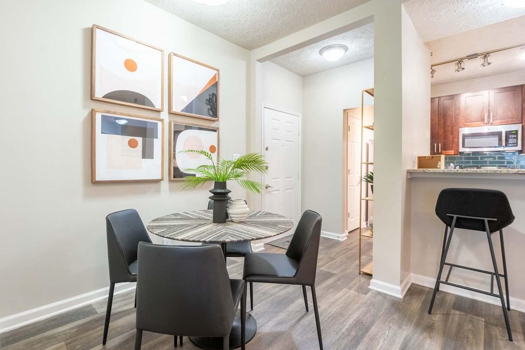 a dining room and kitchen with a table and chairs