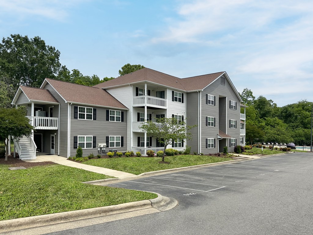 a large apartment building with a street in front of it