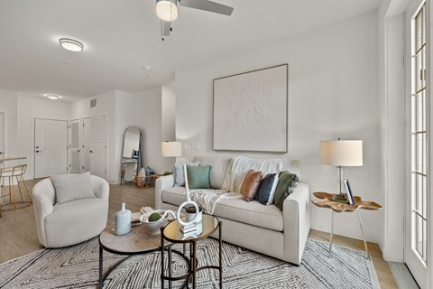 a living room with a couch and a chair and a table