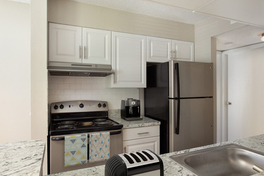 a kitchen with stainless steel appliances and granite counter tops