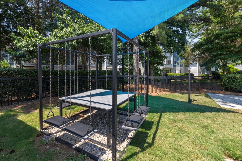 a playground with a swing set and a ping pong table
