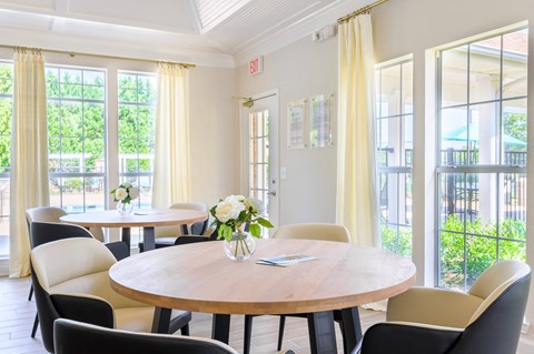 A dining room with a round table and chairs.