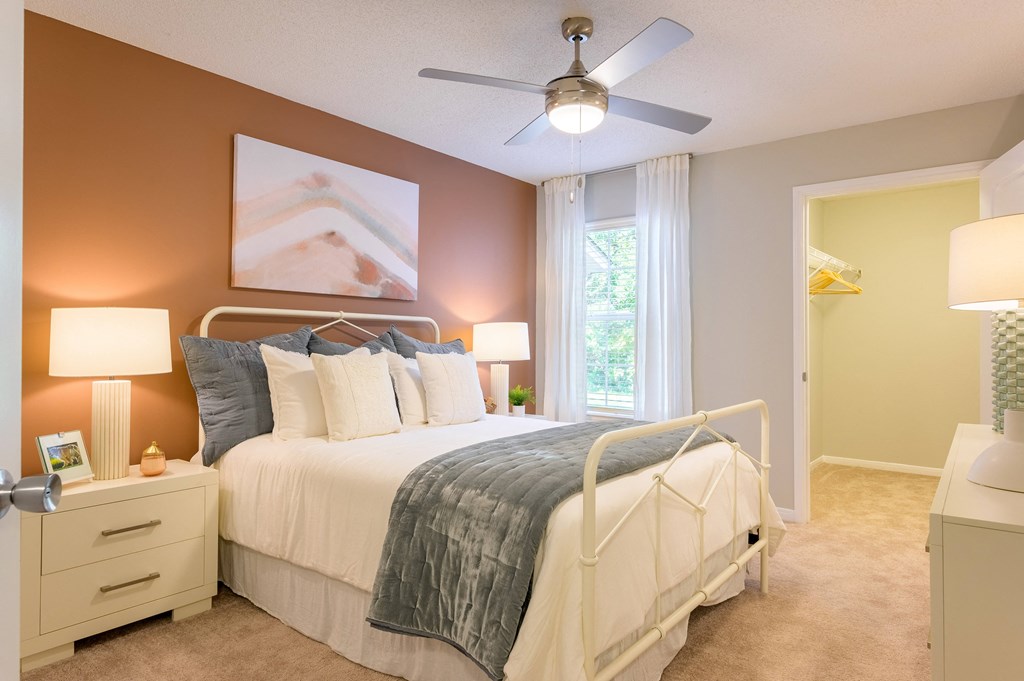 a bedroom with a bed and a ceiling fan