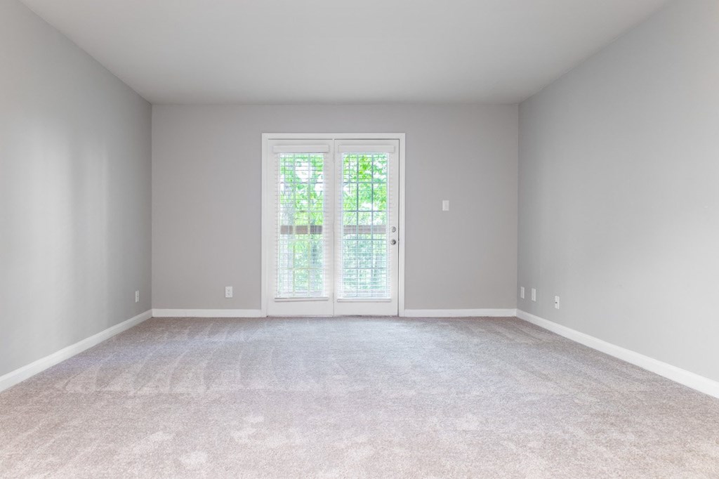 a bedroom with gray walls and a white carpet